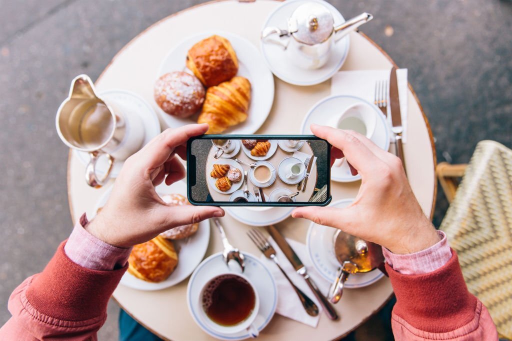 An influencer taking the photo of food